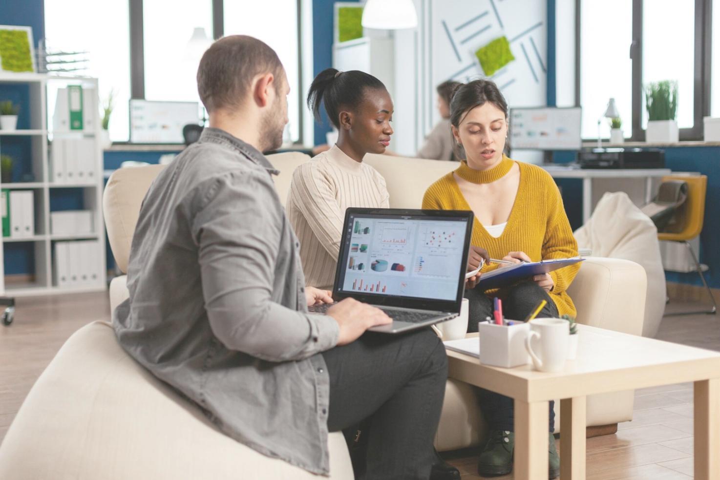 Professional analyst reviewing financial reports and market data on multiple screens